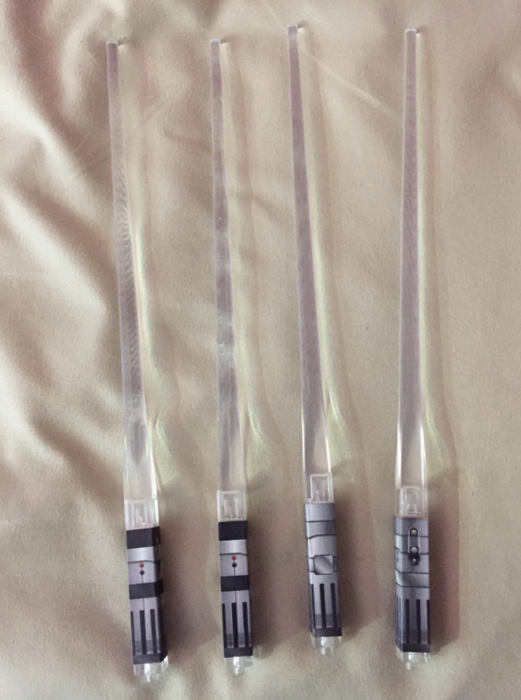 Unlit lightsaber chopsticks.