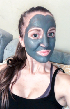 A reviewer with their face covered in the gray mask product.