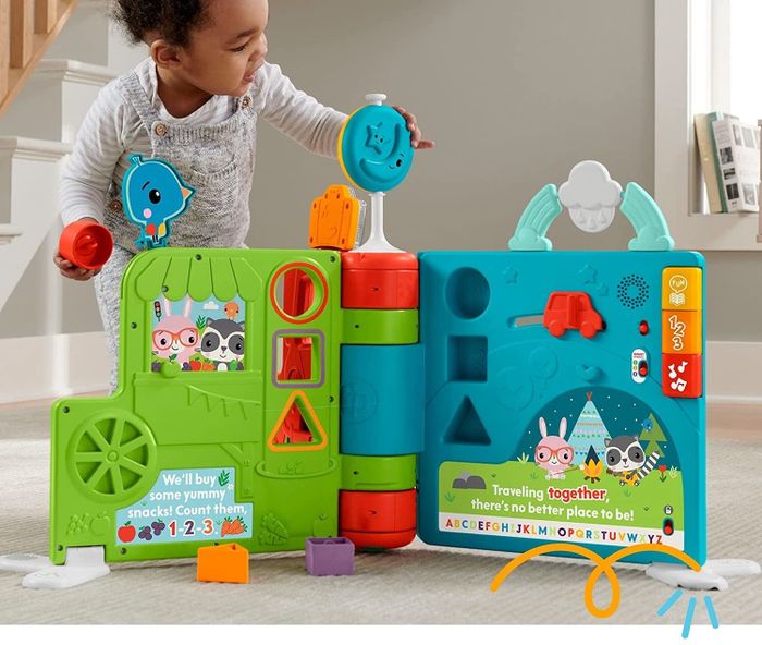 a child interacting with the sit-to-stand activity book, enjoying its features