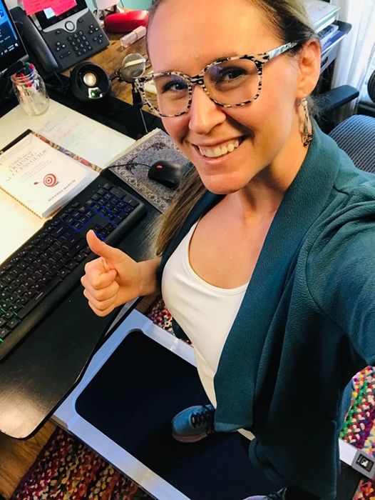 A reviewer walking on the white under-desk treadmill, embracing a productive and active workday.