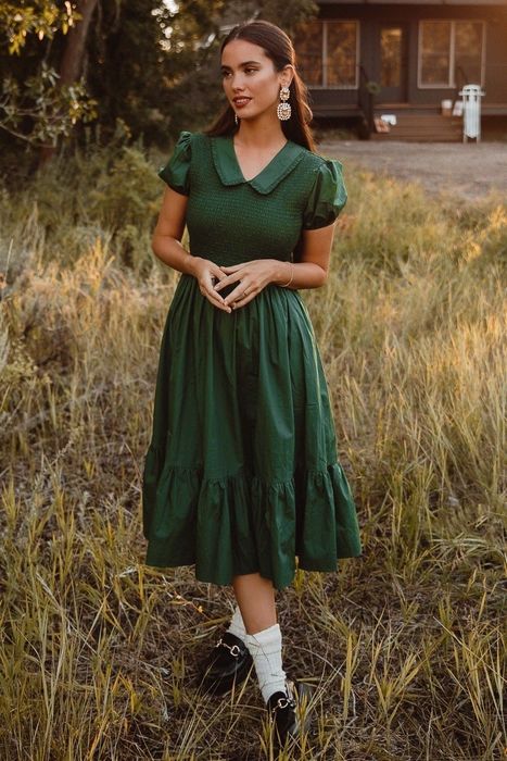 A mid-length green dress with puff sleeves and a cute collar.