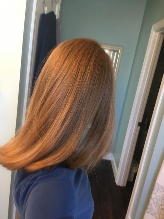 After photo of the same reviewer with smooth, shiny, straightened hair after using the brush