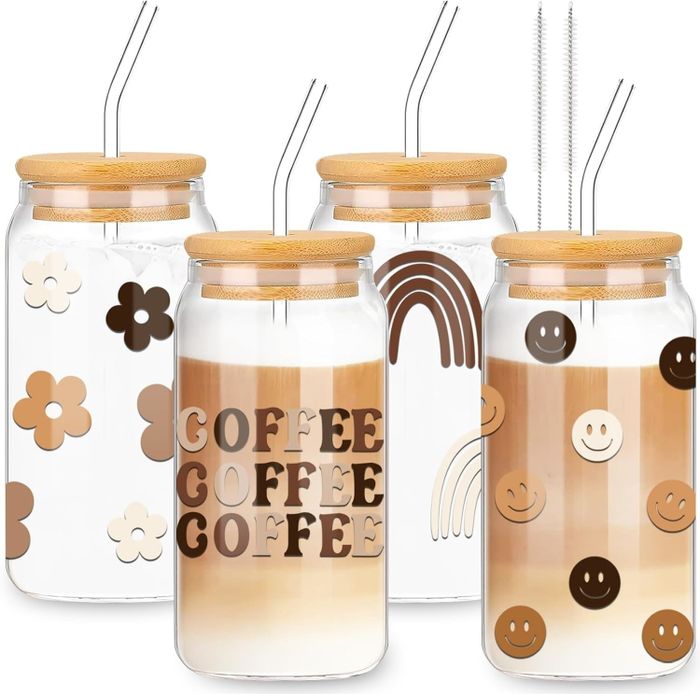 A set of four coffee glasses, each showcasing a unique, neutral-toned design.
