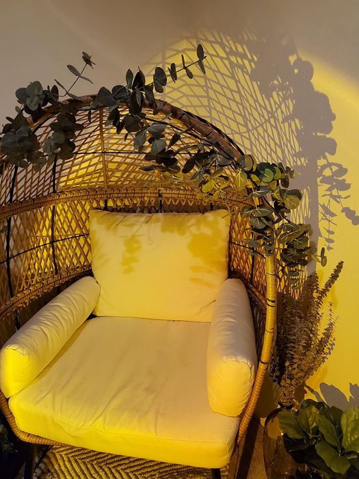 A review photo showcasing the light cast by their sunset lamp on a chair.