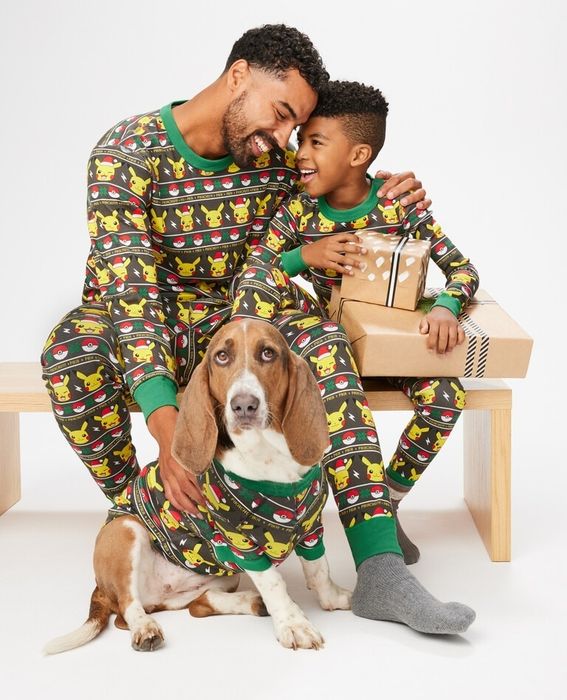 A dad, child, and dog all dressed in matching Pikachu pajamas, spreading the festive spirit and creating the ultimate cozy family moment.