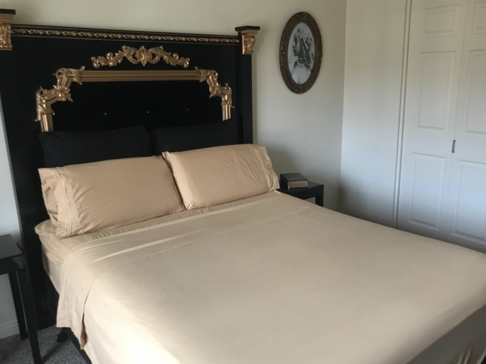 Beige sheets laid out on a bed.