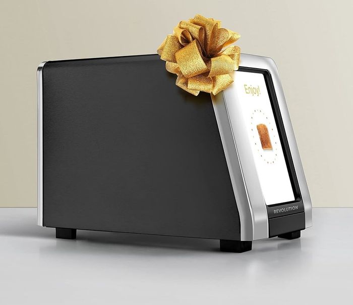 A sleek, matte black Revolution smart toaster, designed to bring a futuristic feel to breakfast time. It’s not just about toasting; it’s about creating the perfect toast with precision and style.