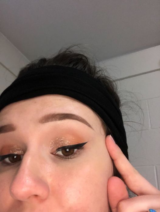 A reviewer photo of them rocking the eyeliner look, demonstrating how the stamp works.