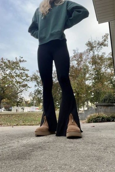 A model showcases black flared leggings.