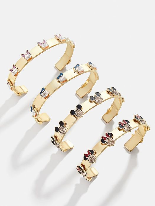 Four gold cuff bracelets, each with a different dazzling Disney character, including Mickey, Minnie, Donald, and Daisy.