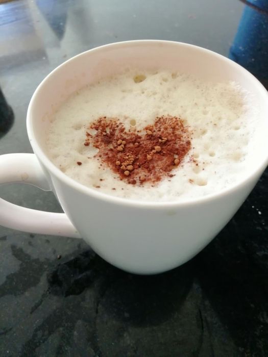 A reviewer’s coffee topped with a perfect, creamy layer of foam.