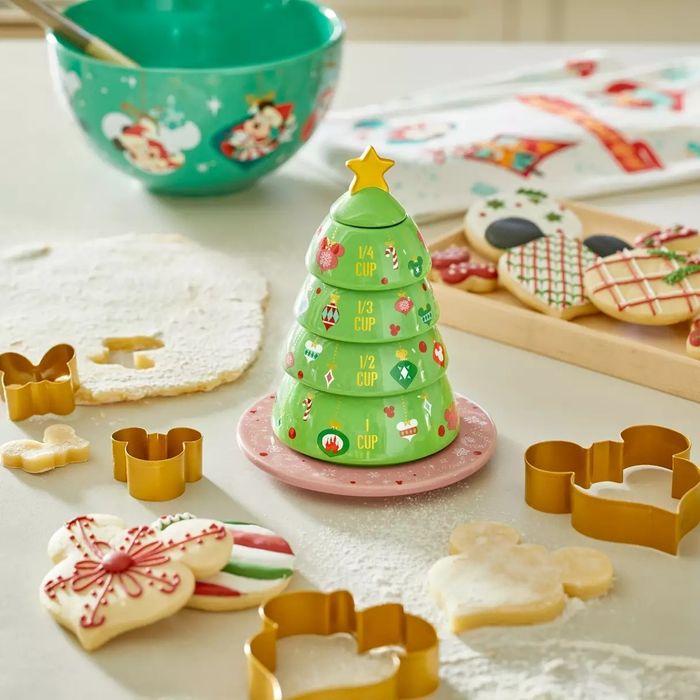 A stack of measuring cups styled to look like a Disney-themed Christmas tree.