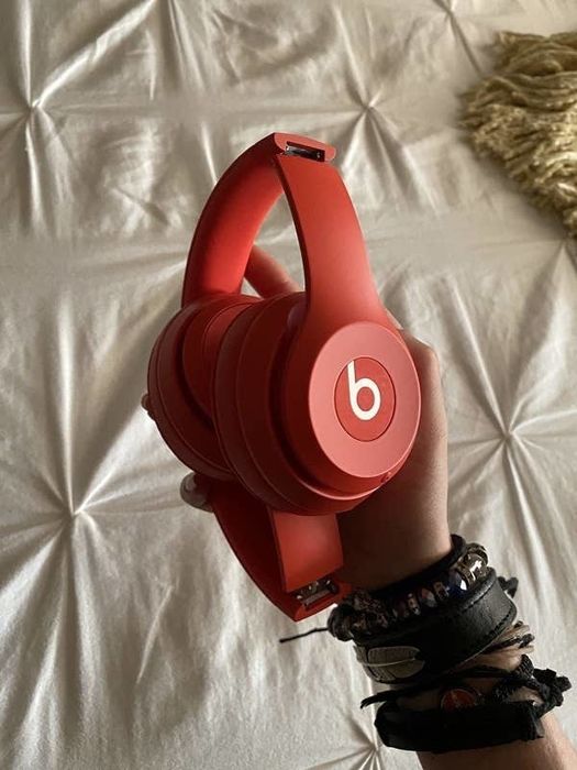 The red headphones neatly folded up.