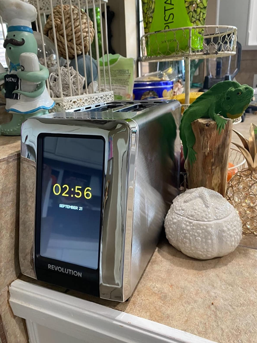 The toaster, when not in use, displays the time on its screen, adding a modern touch to the kitchen while being fully functional for the next round of perfectly toasted items.