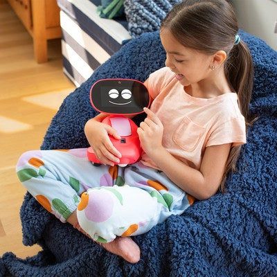 a child holding the Miko 3 robot, with the robot smiling