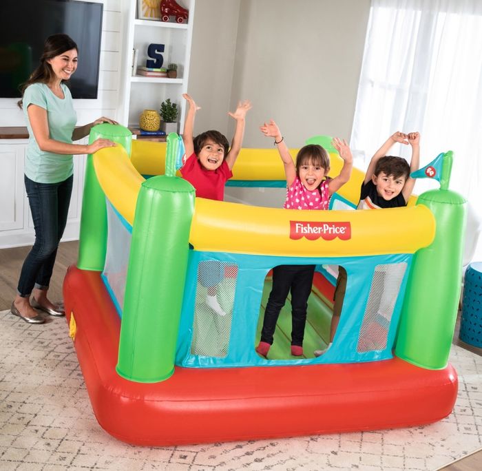 The vibrant bouncy house in yellow, green, blue, and red