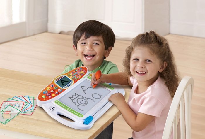 The writing toy in use by two preschoolers