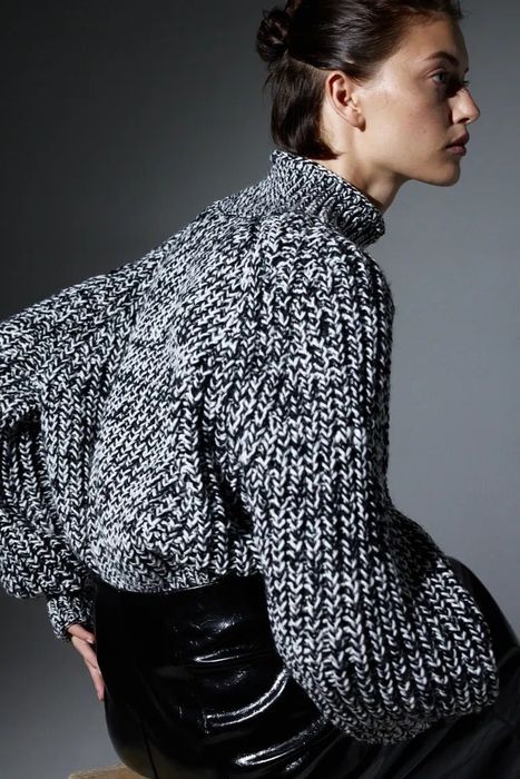 A cozy knit turtleneck sweater in classic black, white, and gray tones.