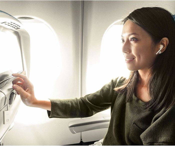 Person enjoying the product on an airplane.