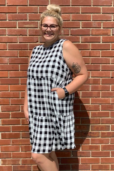 A reviewer in the black and white version of the dress, casually placing a hand in one of the pockets.
