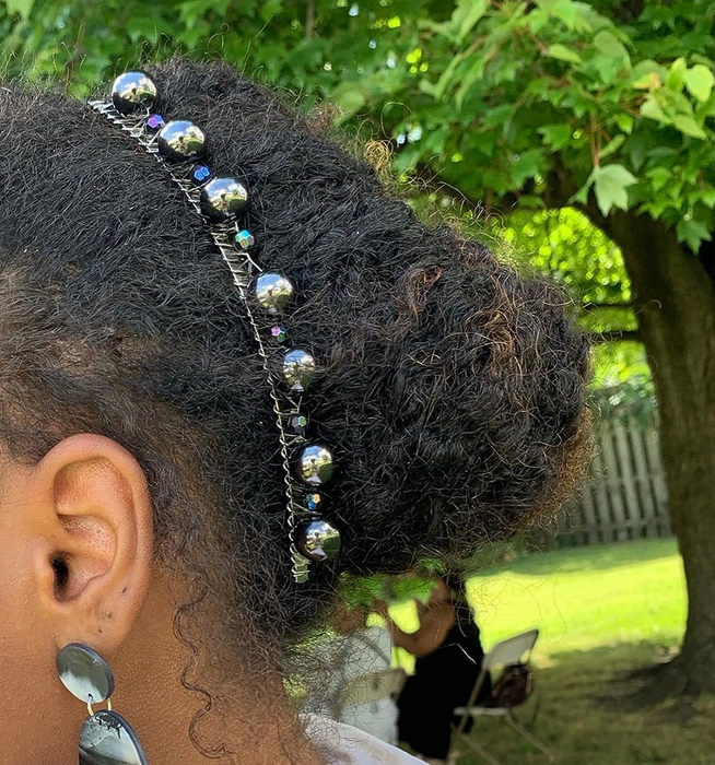 A beaded banana clip holding a reviewer’s hair in an elegant updo
