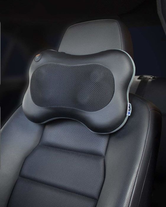 A small massager attached to the top of the car seat.