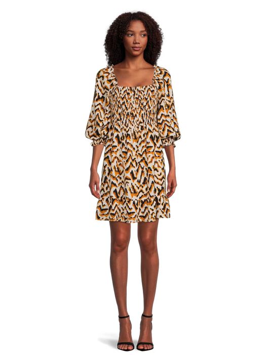 A model wearing a dress featuring a playful feline print