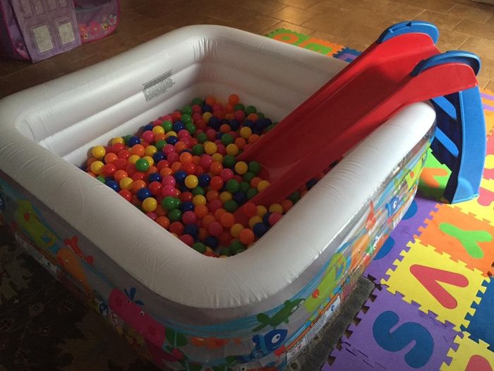 A reviewer’s photo featuring the red slide placed in a ball pit.