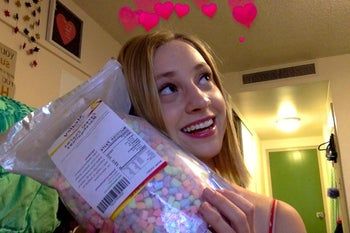 A reviewer holding a bag of cereal marshmallows.
