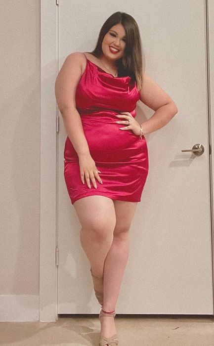 A reviewer showcasing the dress in a rich burgundy color.