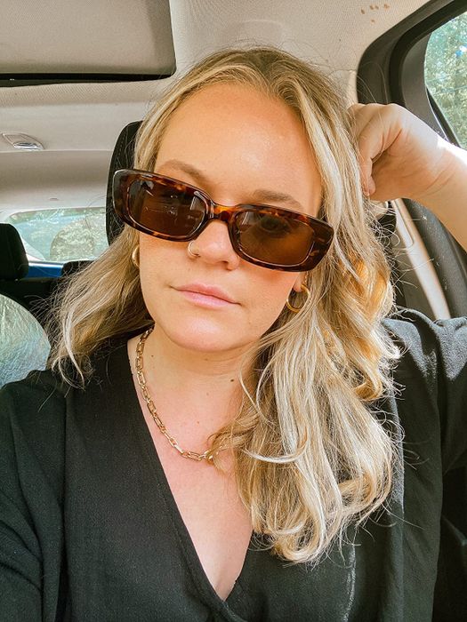 Another reviewer sporting the same sunglasses in a brown hue