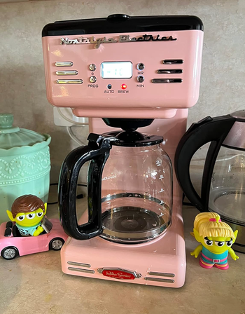 The pastel pink version of the coffee maker.