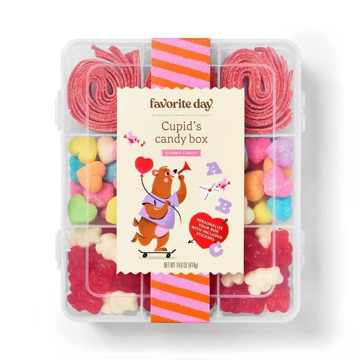 A box of assorted gummy candies, labeled ‘Favorite Day Cupid’s Candy Box,’ featuring heart and alphabet-shaped gummies, with a playful cartoon bear on the label.