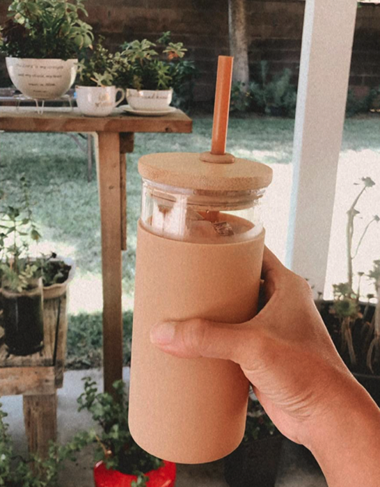 A reviewer holding the tumbler filled with coffee inside