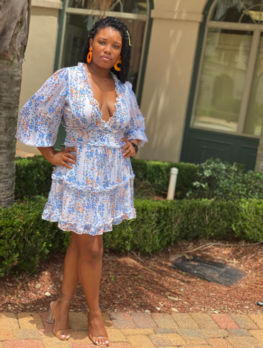A reviewer wearing the ruffle dress paired with heels.
