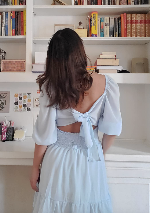 A reviewer wearing the tie-back dress.