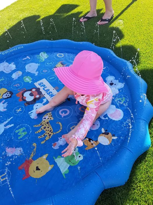 A reviewer’s child having fun splashing around in the splash pad.