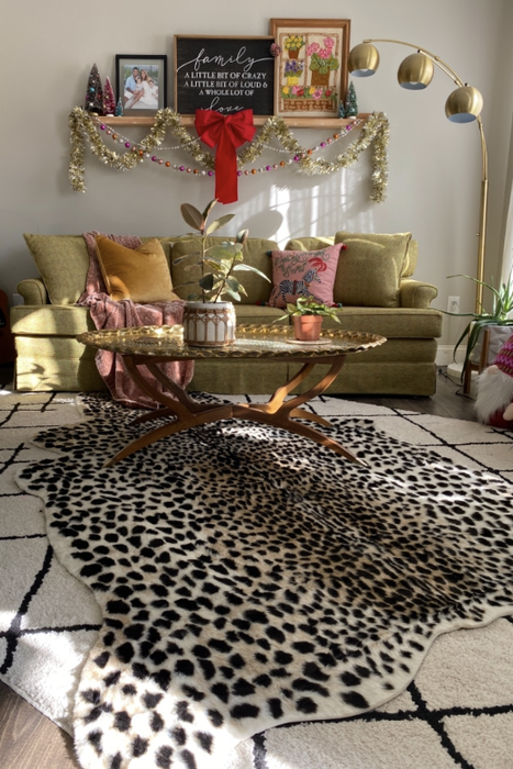 The rug placed over another patterned rug in a maximalist reviewer's room.
