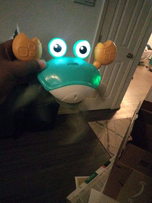 A reviewer's photo of the crab glowing with its lights.