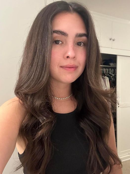 A reviewer showing their hair styled using the hot air brush