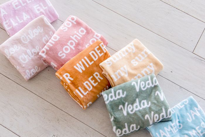 The personalized name blankets available in seven vibrant colors.