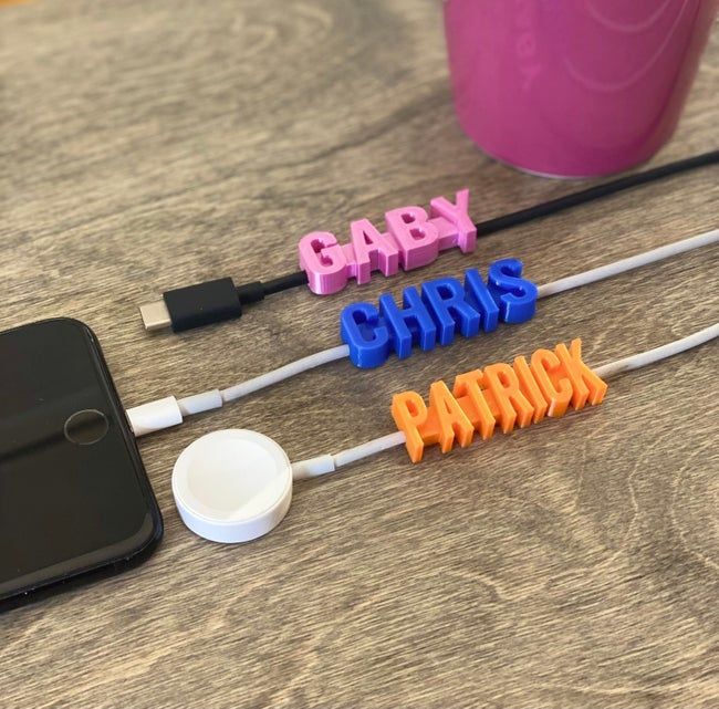 Bright pink, blue, and orange name tags that display the words 