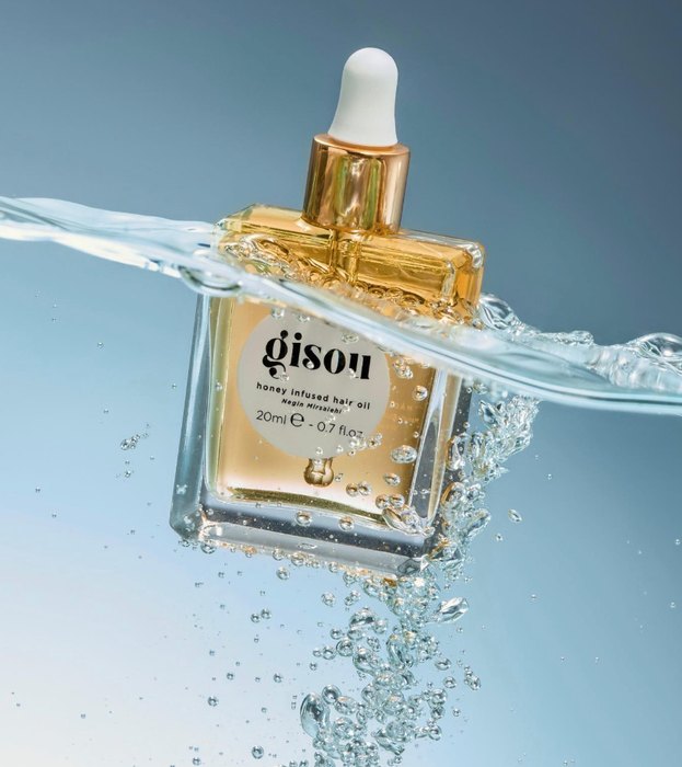 The bottle of hair oil submerged in water