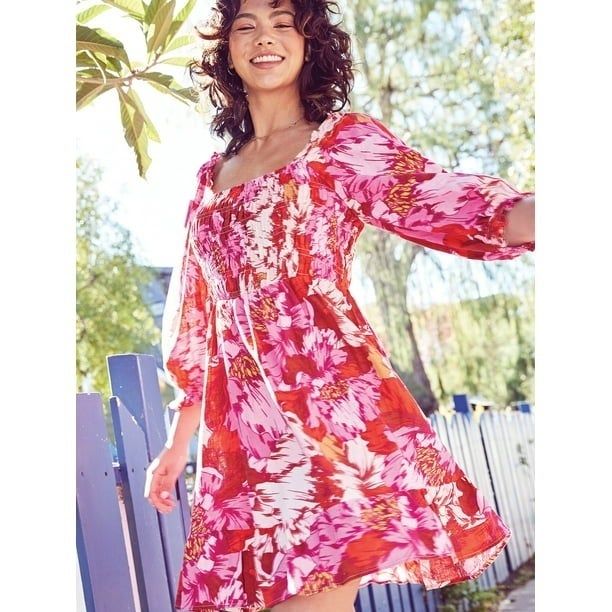 A model rocking a bold red and pink patterned dress