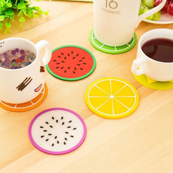 The coasters come in various fruit designs, with some mugs placed on top of them