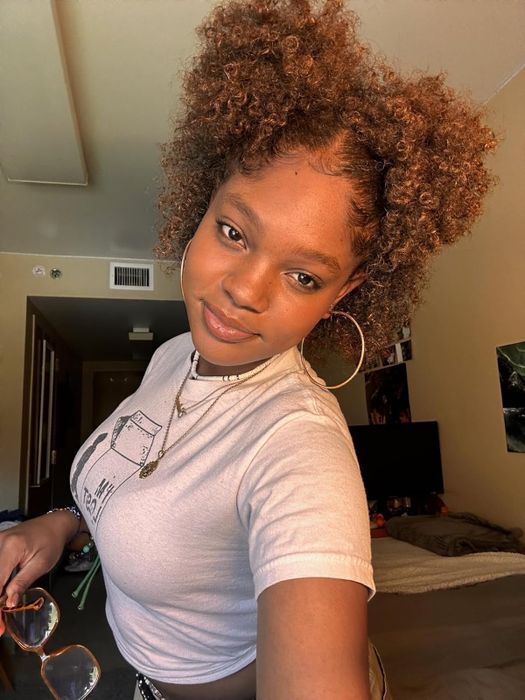 A reviewer showing off their hair after applying copper-colored hair wax.
