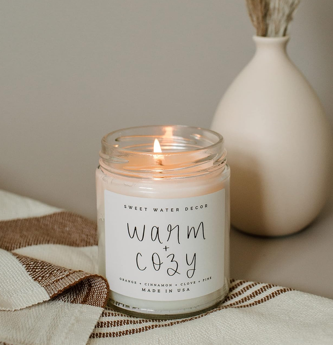 A candle with a white label reading