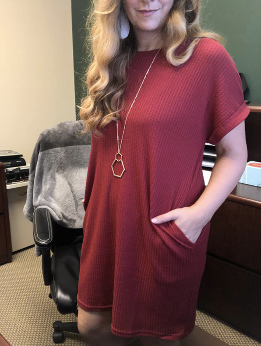 A reviewer wearing the dress, with their hands casually tucked into the pockets.
