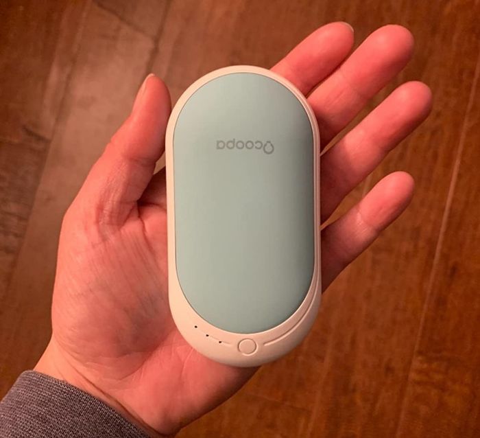 Reviewer holding the hand warmer
