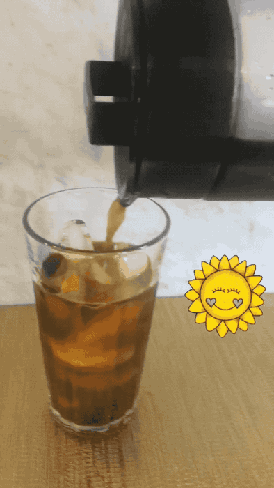 GIF of Maitland pouring cold brew coffee into a glass filled with ice cubes